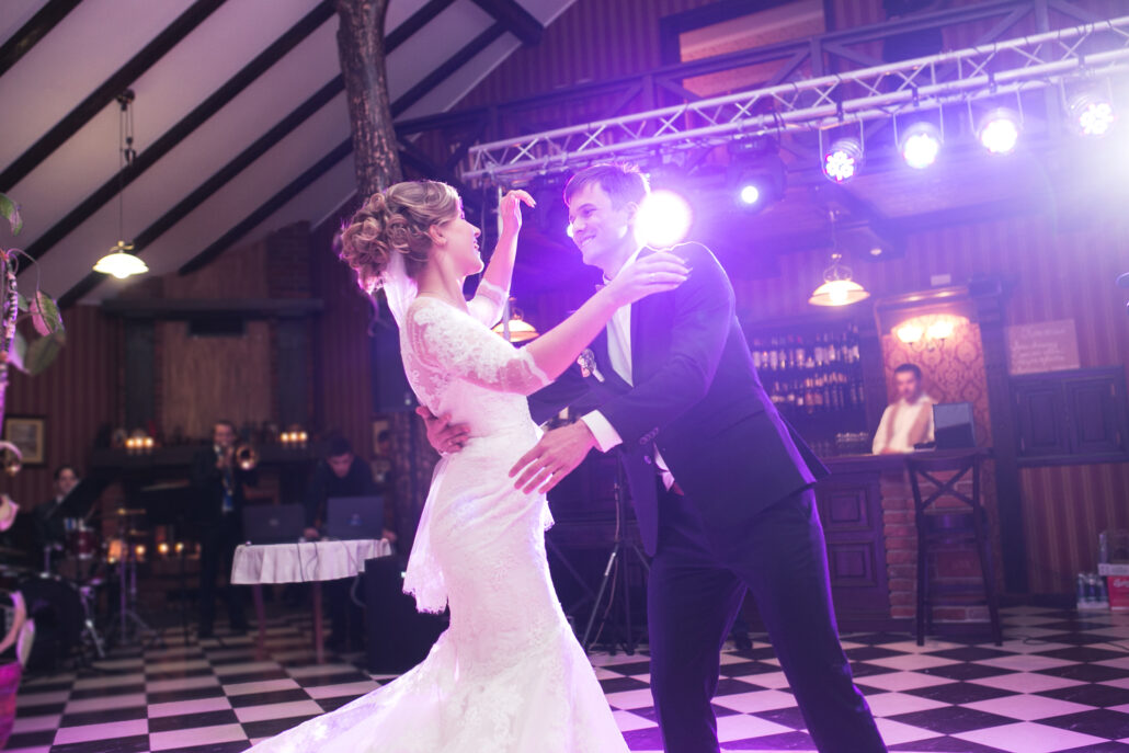 a bride and groom are dancing on the dance floor