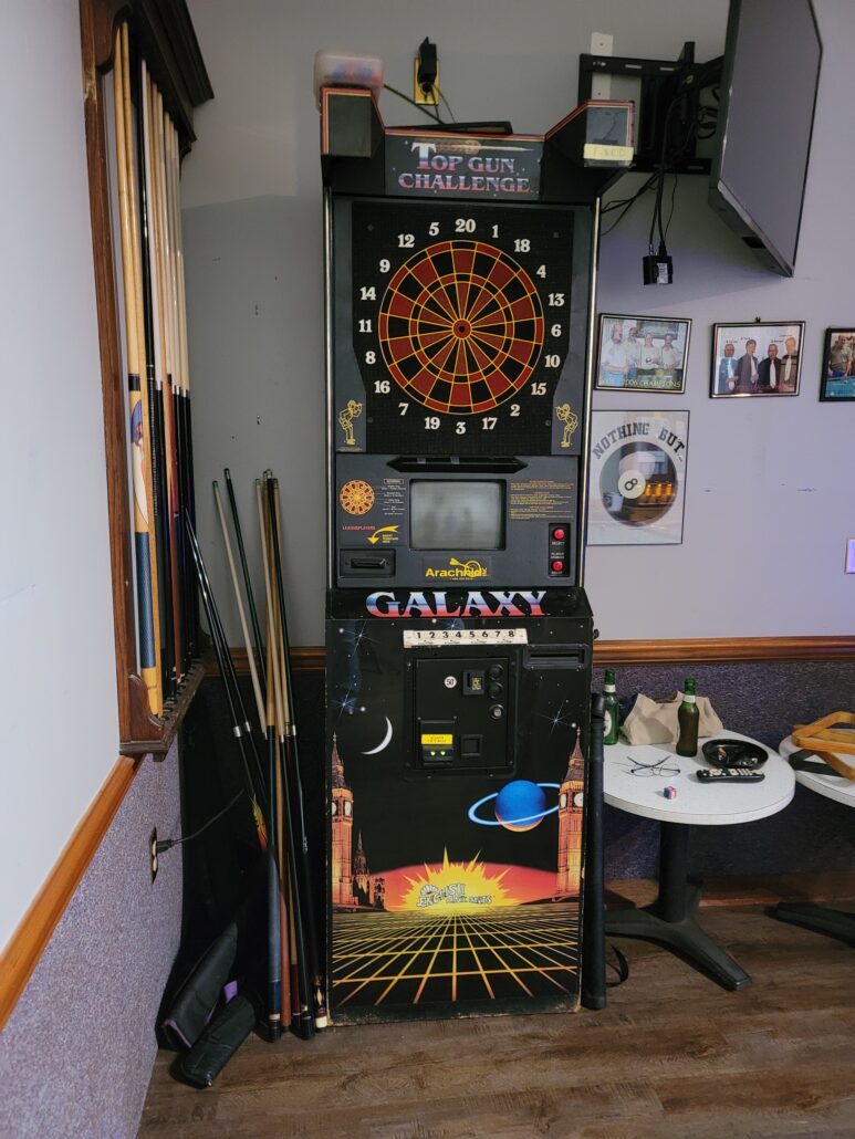 a room with a dart board and various other items